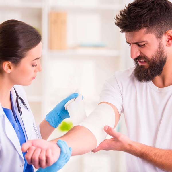 Stretched gauze wrap rolls on injured arm